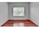 Bright bedroom featuring hardwood floors, a large window, and neutral walls at 3805 Roxwood Park Dr, Buford, GA 30518