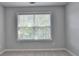 Bright bedroom with neutral carpet, a large window, and neutral walls at 3805 Roxwood Park Dr, Buford, GA 30518