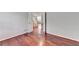 Bedroom featuring hardwood floors, white trim, and a doorway leading to the hallway at 3805 Roxwood Park Dr, Buford, GA 30518