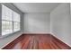 Bright bedroom with hardwood floors and a large window at 3805 Roxwood Park Dr, Buford, GA 30518