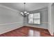 Dining room with hardwood floors, chandelier lighting, and crown molding at 3805 Roxwood Park Dr, Buford, GA 30518