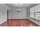 Formal dining room featuring hardwood floors, elegant lighting, and crown molding at 3805 Roxwood Park Dr, Buford, GA 30518
