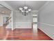 Bright dining room featuring elegant chandelier and rich hardwood flooring at 3805 Roxwood Park Dr, Buford, GA 30518