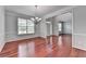 Spacious dining room with gleaming hardwood floors, chair rail, and large windows at 3805 Roxwood Park Dr, Buford, GA 30518