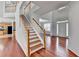 Inviting foyer with hardwood floors, staircase, and a view into the living areas at 3805 Roxwood Park Dr, Buford, GA 30518