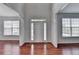 Bright foyer with gleaming hardwood floors and natural light from surrounding windows at 3805 Roxwood Park Dr, Buford, GA 30518