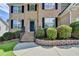 Inviting front entrance with brick steps and landscaped garden beds at 3805 Roxwood Park Dr, Buford, GA 30518