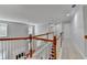 Upstairs hallway features carpet flooring, neutral walls, and wood and white railings at 3805 Roxwood Park Dr, Buford, GA 30518