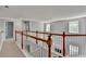 Hallway with wood and white railings, carpet flooring, and natural light at 3805 Roxwood Park Dr, Buford, GA 30518