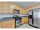 Kitchen featuring wood cabinets, stainless steel appliances, and granite countertops at 3805 Roxwood Park Dr, Buford, GA 30518