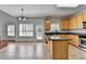 Well-appointed kitchen boasts an island, granite counters, stainless appliances, and ample counter space at 3805 Roxwood Park Dr, Buford, GA 30518