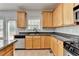 Kitchen featuring wood cabinets, stainless steel appliances, and granite countertops at 3805 Roxwood Park Dr, Buford, GA 30518