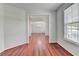 Bright living room featuring hardwood floors and large window with blinds at 3805 Roxwood Park Dr, Buford, GA 30518