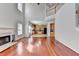 Open living room featuring a fireplace, hardwood floors, and view into kitchen at 3805 Roxwood Park Dr, Buford, GA 30518