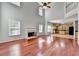 Open living room featuring a fireplace, hardwood floors, and view into kitchen at 3805 Roxwood Park Dr, Buford, GA 30518