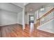 Open living room featuring beautiful hardwood floors and natural lighting at 3805 Roxwood Park Dr, Buford, GA 30518