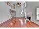 Bright living room features hardwood floors, a fireplace, and large windows providing ample natural light at 3805 Roxwood Park Dr, Buford, GA 30518