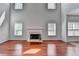 Well-lit living room displays hardwood floors, a fireplace, and generously sized windows at 3805 Roxwood Park Dr, Buford, GA 30518