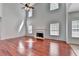 Inviting living room showcasing gleaming hardwood floors, a fireplace, and abundant natural light at 3805 Roxwood Park Dr, Buford, GA 30518