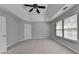 The main bedroom has a ceiling fan and neutral walls and carpet at 3805 Roxwood Park Dr, Buford, GA 30518