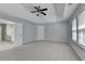 The main bedroom has a ceiling fan, neutral walls, and an attached bathroom at 3805 Roxwood Park Dr, Buford, GA 30518