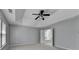 The main bedroom has a ceiling fan and neutral walls and carpet at 3805 Roxwood Park Dr, Buford, GA 30518