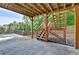 Covered patio with wooden beams and steps leading to the backyard at 3805 Roxwood Park Dr, Buford, GA 30518