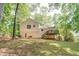 Spacious backyard with deck and mature trees provides privacy and shade at 459 Bakers Bridge Cir, Douglasville, GA 30134