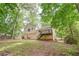 Backyard features mature trees providing shade and a deck for outdoor entertaining at 459 Bakers Bridge Cir, Douglasville, GA 30134