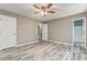 Neutral bedroom features ceiling fan, light grey flooring and 2 separate closets at 459 Bakers Bridge Cir, Douglasville, GA 30134
