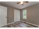 Bedroom with wood-look flooring, closet, and window at 459 Bakers Bridge Cir, Douglasville, GA 30134