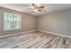 Bright bedroom with ceiling fan, large window and light grey flooring at 459 Bakers Bridge Cir, Douglasville, GA 30134
