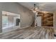 Spacious open living area with light grey flooring, wood accent wall, and access to kitchen at 459 Bakers Bridge Cir, Douglasville, GA 30134
