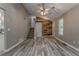 Bright living room featuring hardwood floors, a stairwell, and unique wood accent wall at 459 Bakers Bridge Cir, Douglasville, GA 30134