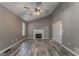 Spacious living room with a fireplace, ceiling fan, and hardwood floors at 459 Bakers Bridge Cir, Douglasville, GA 30134