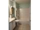 Bathroom featuring a bathtub with shower and vanity with storage at 802 Village Pl, Loganville, GA 30052