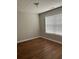 A bedroom with hardwood floors and a window for natural light at 802 Village Pl, Loganville, GA 30052