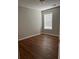 A bedroom with hardwood floors and a window for natural light at 802 Village Pl, Loganville, GA 30052