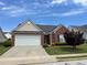 Charming single-story home with a well-manicured lawn and a two-car garage at 802 Village Pl, Loganville, GA 30052