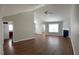 Open-concept living room with hardwood floors, a fireplace, and neutral paint at 802 Village Pl, Loganville, GA 30052