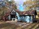 Charming blue home featuring a spacious patio and a delightful second-story balcony at 125 Toccoa Rd, Carrollton, GA 30116