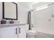 Clean bathroom featuring a granite countertop, white vanity, and a shower/tub combo at 461 Barnwood Dr, Rockmart, GA 30153