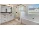 Bathroom with double shower head, bathtub, and granite counters at 461 Barnwood Dr, Rockmart, GA 30153