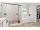 Bathroom with a glass shower, tub, and door leading to the walk-in closet at 461 Barnwood Dr, Rockmart, GA 30153