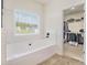 Bathroom with a soaking tub and access to the walk-in closet at 461 Barnwood Dr, Rockmart, GA 30153