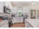 Bright, stylish kitchen with white cabinets, granite countertops, stainless steel appliances, and ample counter space at 461 Barnwood Dr, Rockmart, GA 30153