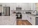 Kitchen features granite counters, stainless steel appliances, and white cabinets for a clean, modern look at 461 Barnwood Dr, Rockmart, GA 30153