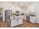Modern kitchen featuring white cabinets, granite countertops, stainless steel appliances, and a functional center island at 461 Barnwood Dr, Rockmart, GA 30153
