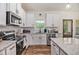 Bright, stylish kitchen with white cabinets, granite countertops, stainless steel appliances, and ample counter space at 461 Barnwood Dr, Rockmart, GA 30153