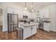 Well-lit kitchen complete with white cabinets, granite countertops, stainless steel appliances, and a convenient center island at 461 Barnwood Dr, Rockmart, GA 30153